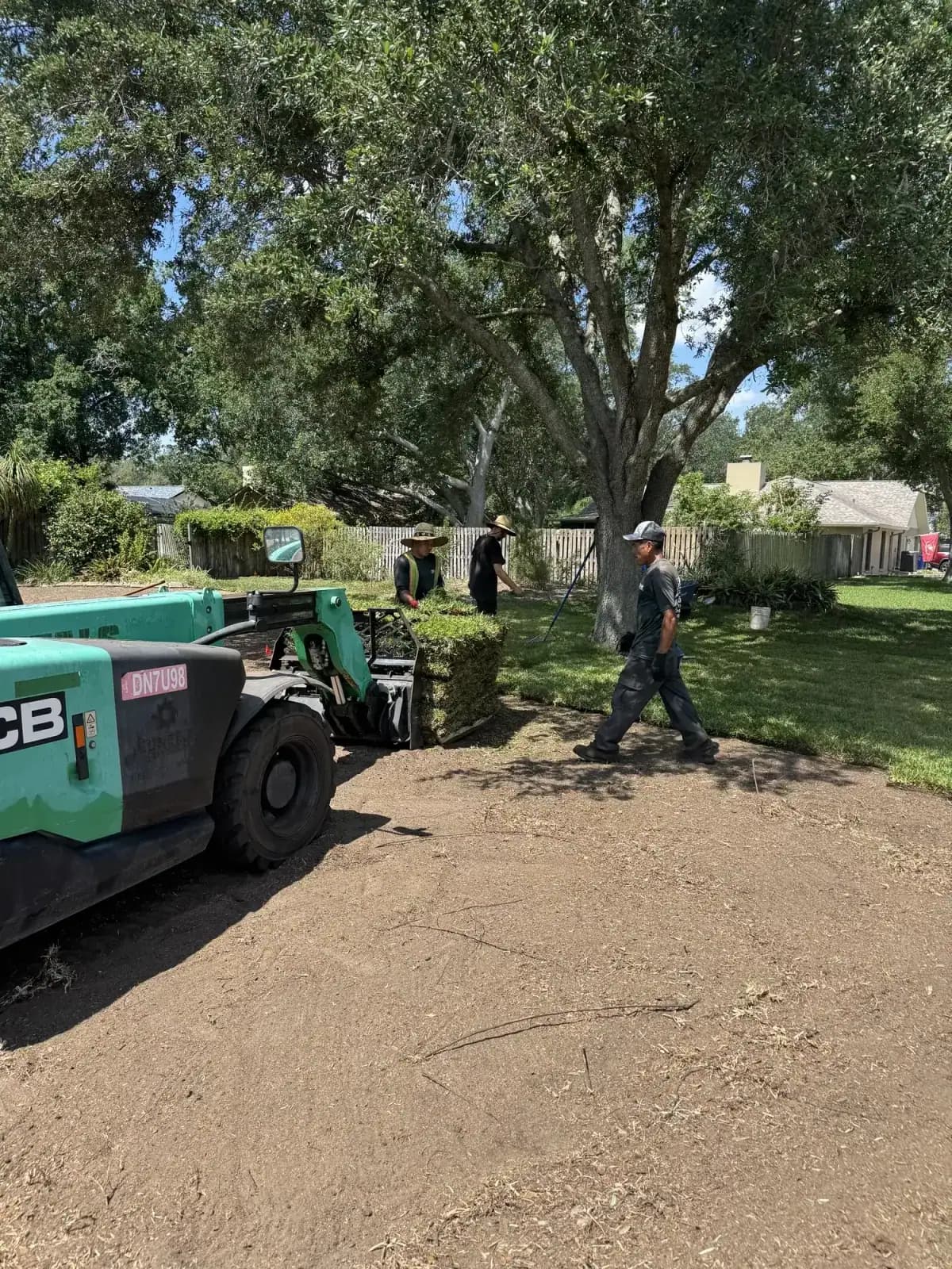 The Sod-X crew removing and installing a lawn with their loader on a Tampa Bay property